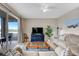 Comfortable living room with a decorative cabinet, plush seating, and sliding door access to a balcony at 7911 Grand Estuary Trl # 106, Bradenton, FL 34212