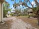 Spacious backyard featuring a screened patio, a gazebo, and lush greenery at 8107 High Oaks Trl, Myakka City, FL 34251