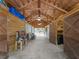Bright barn interior with ceiling fans, stalls, and wood construction throughout at 8107 High Oaks Trl, Myakka City, FL 34251