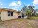Backyard view with screened-in pool and landscaping with an extended lawn, ideal for outdoor activities at 8107 High Oaks Trl, Myakka City, FL 34251