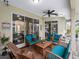 Covered outdoor patio with seating area, ceiling fan, and view of the pool, ideal for relaxation and entertainment at 8107 High Oaks Trl, Myakka City, FL 34251