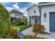 Charming home with well-maintained landscaping, paver walkway, and blue shutters providing an inviting curb appeal at 12810 Seasong Ter, Bradenton, FL 34211