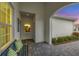 Inviting front porch featuring paver flooring, comfortable bench seating, and serene outdoor ambiance at 12810 Seasong Ter, Bradenton, FL 34211