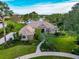 Beautiful home with water view, manicured lawn, mature trees, and lush landscaping at 16806 5Th Ne Ter, Bradenton, FL 34212