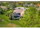 Aerial view of home with screened-in pool, lush landscaping, and a well-maintained green lawn at 16806 5Th Ne Ter, Bradenton, FL 34212