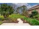 Scenic backyard featuring a lush lawn, diverse greenery, and a glimpse of a serene lake at 16806 5Th Ne Ter, Bradenton, FL 34212