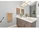 Neutral bathroom with a vanity, mirror and decorative artwork and towel at 16806 5Th Ne Ter, Bradenton, FL 34212