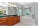 An elegant bathroom with a soaking tub, wood cabinets, and granite countertops at 16806 5Th Ne Ter, Bradenton, FL 34212