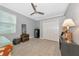 Neutral bedroom featuring a ceiling fan, accent table, and double door closet at 16806 5Th Ne Ter, Bradenton, FL 34212