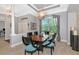 Formal dining room features a decorative light fixture, coffered ceiling and views of the backyard at 16806 5Th Ne Ter, Bradenton, FL 34212