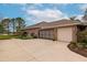 Spacious home exterior with a three-car garage, wide driveway, well-maintained landscaping, and tile roof at 16806 5Th Ne Ter, Bradenton, FL 34212