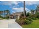 Exterior view of a home with a three-car garage, long driveway, tile roof, and manicured landscaping at 16806 5Th Ne Ter, Bradenton, FL 34212