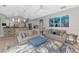 Bright living room featuring leather sofas, modern decor, and an open-concept layout connected to the kitchen at 16806 5Th Ne Ter, Bradenton, FL 34212