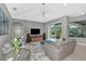 Living room with furniture, tv, decor, ceiling fan, luxury vinyl plank flooring and backyard views at 16806 5Th Ne Ter, Bradenton, FL 34212