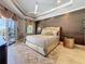 Main bedroom suite with modern furniture, wood accent wall, and private access to the lanai at 16806 5Th Ne Ter, Bradenton, FL 34212