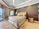 This main bedroom features a decorative ceiling, wood accent wall, and sliding glass doors to the lanai at 16806 5Th Ne Ter, Bradenton, FL 34212