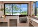 View of the lake from the outdoor kitchen with stainless steel grill and compact refrigerator at 16806 5Th Ne Ter, Bradenton, FL 34212