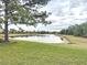 Scenic view of a pond surrounded by lush greenery and trees, showcasing a tranquil outdoor setting at 16806 5Th Ne Ter, Bradenton, FL 34212