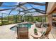 Serene pool area surrounded by a screened enclosure, featuring comfortable seating and well-manicured landscaping at 16806 5Th Ne Ter, Bradenton, FL 34212