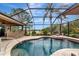 Inviting pool area with a screened enclosure, featuring lake views and an adjacent outdoor dining space at 16806 5Th Ne Ter, Bradenton, FL 34212