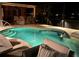 Relaxing outdoor pool area with lounge seating, built-in bar, and decorative lighting for evening enjoyment at 16806 5Th Ne Ter, Bradenton, FL 34212