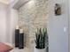 Interior with stacked stone accent wall, decorative sconces, and a potted plant at 16806 5Th Ne Ter, Bradenton, FL 34212