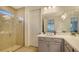 Clean bathroom with a glass shower, white vanity, and a large mirror at 204 Villoresi Blvd, Nokomis, FL 34275