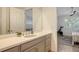 Modern bathroom with a large mirror, white vanity, and gray cabinets at 204 Villoresi Blvd, Nokomis, FL 34275