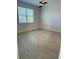 Neutral bedroom with wood-look tile flooring and a window with blinds at 204 Villoresi Blvd, Nokomis, FL 34275