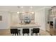 Bright kitchen featuring gray cabinets, stainless steel appliances, and island with granite countertop at 204 Villoresi Blvd, Nokomis, FL 34275