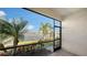 A screened lanai showcasing tranquil lake views and lush tropical landscaping at 204 Villoresi Blvd, Nokomis, FL 34275