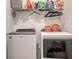 A functional laundry room with modern washer and dryer and convenient overhead shelving at 204 Villoresi Blvd, Nokomis, FL 34275