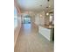 Open concept living room and kitchen area with wood-look tile flooring and views of the lake at 204 Villoresi Blvd, Nokomis, FL 34275