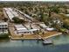 Aerial view of waterfront community with private docks and lush green landscaping by the water at 2107 Palma Sola Blvd # 27, Bradenton, FL 34209