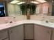 Bright bathroom boasts a double sink vanity with ample counter space and decorative hanging plants at 2107 Palma Sola Blvd # 27, Bradenton, FL 34209