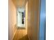 Clean hallway with paneled walls and wood floors, providing access to various rooms in the home at 2107 Palma Sola Blvd # 27, Bradenton, FL 34209