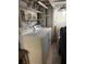 Functional laundry area featuring a washer, dryer, sink, and storage shelves, offering convenience and practicality at 2107 Palma Sola Blvd # 27, Bradenton, FL 34209
