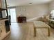 Open living room includes wood laminate floors, neutral walls, and sliding glass doors to the sun room at 2107 Palma Sola Blvd # 27, Bradenton, FL 34209
