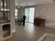 Open-concept living room has wood floors and access to the glass-enclosed sunroom at 2107 Palma Sola Blvd # 27, Bradenton, FL 34209
