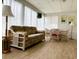 Sunroom with furniture, light wood floors, bright sheer curtains, and large windows at 2107 Palma Sola Blvd # 27, Bradenton, FL 34209