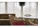 Sunroom with large windows, sheer white curtains, light wood floors, sofa, and a table with chairs at 2107 Palma Sola Blvd # 27, Bradenton, FL 34209