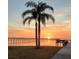 Sunset view of waterfront includes a pier, dock, and colorful evening sky at 2107 Palma Sola Blvd # 27, Bradenton, FL 34209