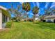 Large grassy backyard with mature trees providing shade for relaxing or entertaining at 4045 Oakhurst Dr # 3125, Sarasota, FL 34233