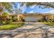 Charming one-story home with a two-car garage, well-maintained lawn, and beautiful landscaping at 4045 Oakhurst Dr # 3125, Sarasota, FL 34233