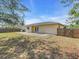 Enjoy outdoor living with a concrete patio and a spacious backyard, fully fenced for privacy at 1382 Ronald St, North Port, FL 34286