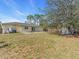 This large backyard features a patio, fencing, and ample lawn space for outdoor activities and entertaining at 1382 Ronald St, North Port, FL 34286