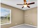 This bedroom features a large window for natural light and a ceiling fan for comfortable temperature control at 1382 Ronald St, North Port, FL 34286