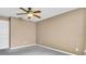 Bedroom with gray carpet, neutral walls and ceiling fan; blank canvas for customization at 1382 Ronald St, North Port, FL 34286