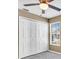 This bedroom includes a ceiling fan, natural light from the window, and a convenient closet at 1382 Ronald St, North Port, FL 34286