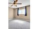 Cozy bedroom boasts soft carpeting and windows with decorative curtains at 1382 Ronald St, North Port, FL 34286